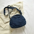 Deep blue denim crescent shoulder bag with adjustable black strap on white blazer - Dark Blue
