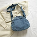 Blue denim crossbody dumpling bag with adjustable strap on white background - Light Blue