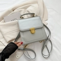 Silver grey square handbag with golden metallic lock and adjustable strap on a blazer - Silver No Pendant