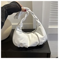 Detail of white pleated cloud bag featuring a unique braided handle and metal zipper - White