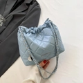 Sky blue quilted cloud bucket bag with silver chain strap and matte leather finish - Blue