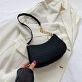 Retro black quilted suede underarm bag with gold chain strap on a white blazer - Black