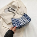 Ethnic blue and white geometric woven underarm bag with silver chain strap on a blazer - Style 1 Blue