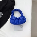 Electric blue pleated handbag in glossy PU leather shown with a smartphone for scale - Sapphire Blue