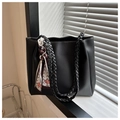 Detail of black faux leather tote bag with braided handles and floral scarf decoration - Black
