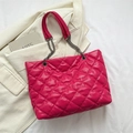 Fuchsia quilted tote bag with chain strap displayed on a beige textured blazer - Rose Pink