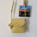 Yellow textured leather crossbody bag with flap and decorative elephant charm - Light Yellow