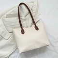 Chic cream tote bag with brown straps and curved top edge on beige blazer background - 37*25.5*13 / White