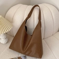 Minimalist vintage dark brown tote bag with smooth leather texture on a cozy sofa - Brown