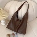 Large vintage dark brown faux leather tote bag on a cozy sofa for autumn fashion - Brown