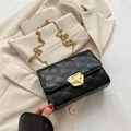 Chic black embossed crossbody bag with golden chain strap and geometric pattern - Black