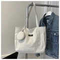 Detalle del bolso tote de pana crema con rayas texturizadas y un pequeño bolso redondo - Blanco