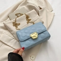 Light blue quilted shoulder bag with gold geometric buckle and delicate chain strap - Blue