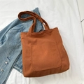 Deep caramel corduroy tote bag with front pocket and snap button on denim jacket - Brown