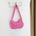 Pink popcorn textured shoulder bag with a crescent shape and stylish pleated fabric design - Pink