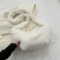 White faux fur crossbody dumpling bag in soft plush material for winter fashion - White
