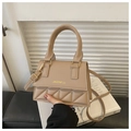 Detail of nude crossbody bag with diamond quilting, top handle and golden brand stamp - Khaki