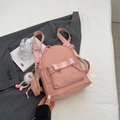 Mini pink backpack for women featuring a bow design and cute monster plush pendant - Pink With Pendant