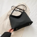 Classic black nylon hobo tote bag with gold metal rivets on base for daily commute - Black