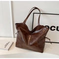 Close-up of the deep brown faux leather tote bag with glossy finish and side drawstring - Coffee