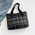 Minimalist black quilted tote bag with glossy finish and durable fabric handles - Black