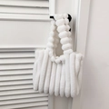 White faux fur tote bag with quilted texture and plush ball handle for autumn and winter - White