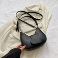 Minimalist black crescent shoulder bag featuring a heart-shaped flap with LOVE embossing - Black