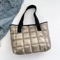 Champagne gold quilted down tote bag with black canvas straps on white background - Champagne
