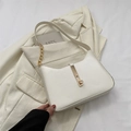 Chic cream white underarm bag featuring a gold buckle and metal chain shoulder strap - White