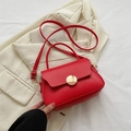 Chic vibrant red crossbody shoulder bag with a stylish gold circular buckle clasp - Red