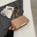 Beige crossbody chain bag with V-shaped quilting on elegant gray suit background - Khaki