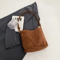 Brown suede tote bag with knotted shoulder straps and vintage aesthetic on grey blazer - Matte Coffee