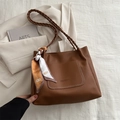 Brown litchi leather tote bag with woven handles and a decorative printed silk scarf - Brown