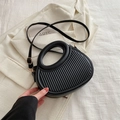 Minimalist black handbag with unique round hollow handle and striped texture detail - Black