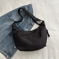 Black crescent crossbody bag with wide strap and woven rope zipper detail - Black