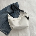 Minimalist white half-moon crossbody bag with adjustable black strap and knot zipper detail - White