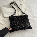 Detail of black sequin tote bag with knotted leather strap on neutral blazer background - Black