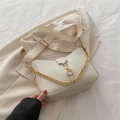 Minimalist creamy white chain shoulder bag with gold hardware and wide strap on beige suit - White