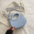 Light blue crossbody dumpling bag with vertical textured stripes and gold hardware - Blue