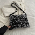 Detailed close-up of glossy black sequins and textured fabric on a stylish shoulder bag - Silver