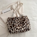 Furry leopard print tote bag with metal chain strap on minimalist beige background - White