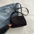 Bolso de pana negra con herrajes dorados y correa de cuero sobre fondo de mezclilla - Negro