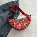 Red half-moon crossbody bag with traditional floral pattern and adjustable strap - Red