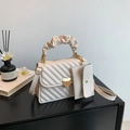 Beige quilted handbag with heart lock and gathered handle featuring a matching mini pouch - Off White