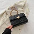 Chic black quilted crossbody bag with heart-shaped gold lock and chain strap - Black
