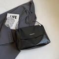 Glossy black faux leather crossbody bag with metal chain strap and minimalist bar detail - Black