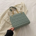 Morandi green quilted crossbody tote bag with gold chain strap on a white blazer - Green