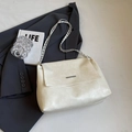 Creamy white leather crossbody bag with metal chain strap on minimalist background - White