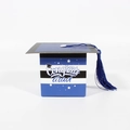 Close-up of blue graduation cap favor box with tassel and Congrats Grad text on stripes - Blue