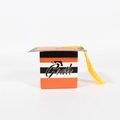 Detail of orange and black striped graduation cap candy box with yellow tassel decoration - Orange